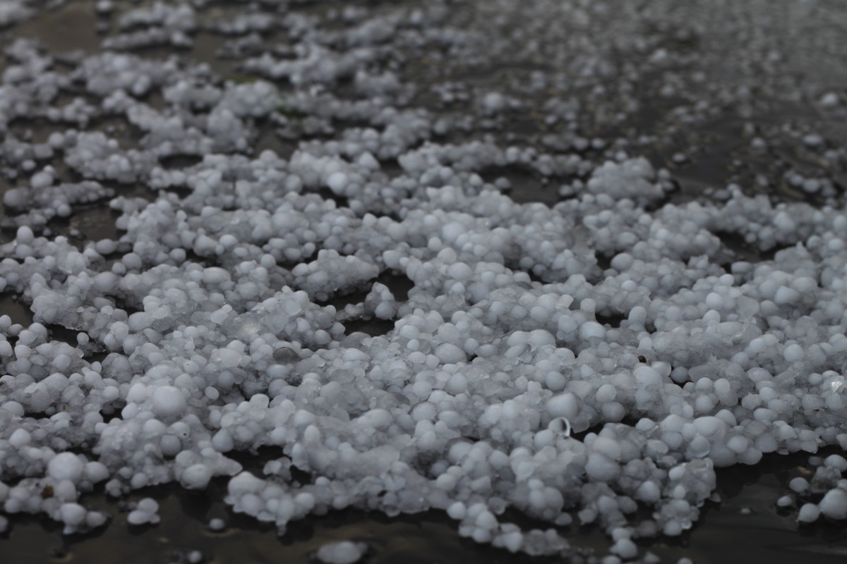 hail scattered on a dark surface outdoors